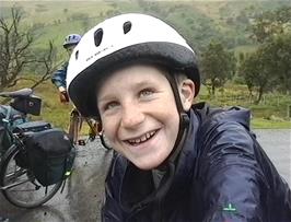 Alasdair as cheerful as ever despite the unpleasant weather, although his good spirits are partly due to the generosity of Luke and Llewellyn in carrying his panniers
